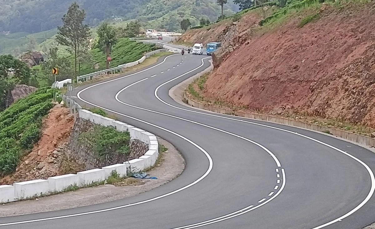 A finished highway curves through the mountain slopes between Munnar and Bodimettu.