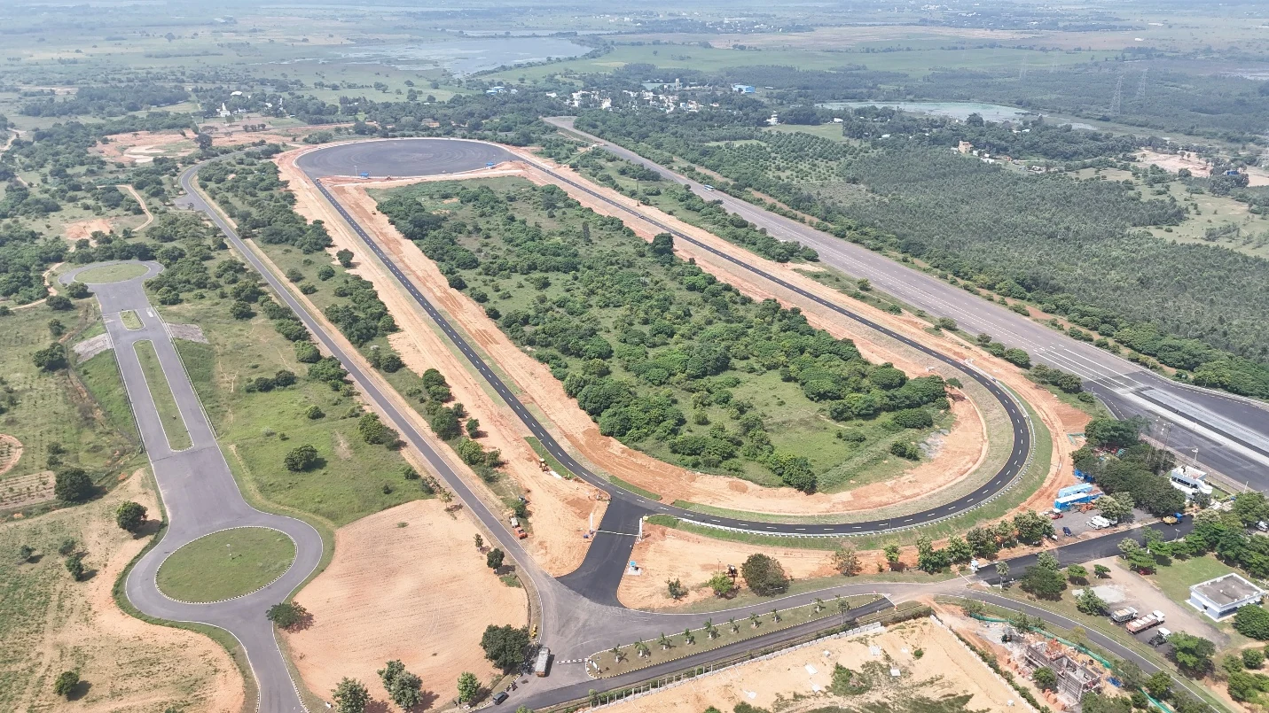 Aerial photograph of the ZF automotive test facility with a long oval track and approach roads.